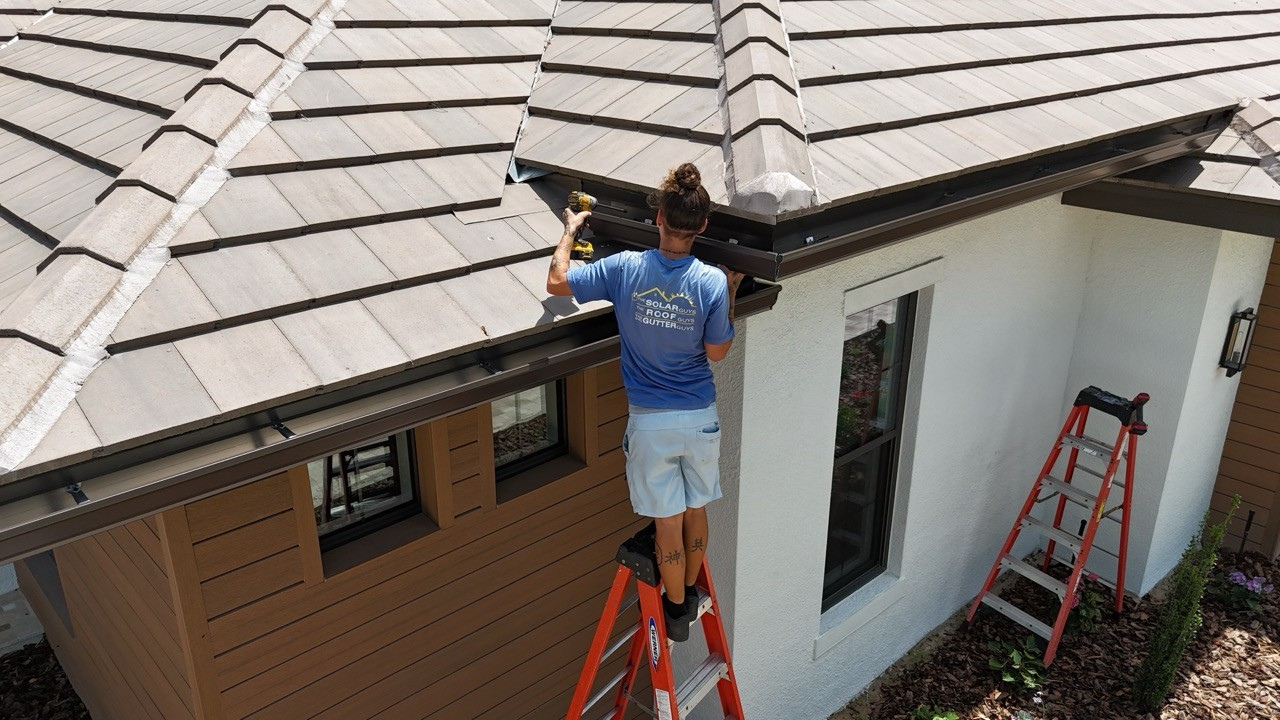 custom seamless gutters being installed on home